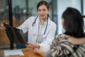 A doctor discusses chest X-ray results with her patient, explaining the health findings in a clear and supportive manner. photo