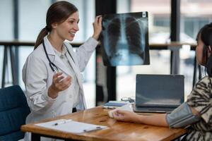 A doctor discusses chest X-ray results with her patient, explaining the health findings in a clear and supportive manner. photo