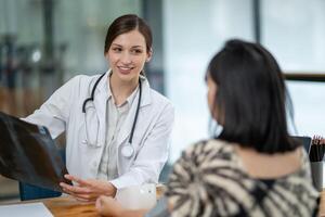 A doctor discusses chest X-ray results with her patient, explaining the health findings in a clear and supportive manner. photo
