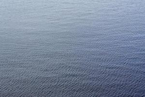 The texture of ripples on the water. Natural background. photo