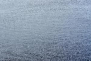 The texture of ripples on the water. Natural background. photo