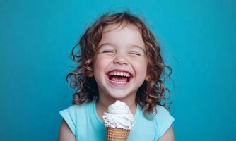 A little girl is smiling while holding an ice cream cone photo