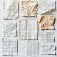 An assortment of crumpled and aged grid papers, displaying various folds and wrinkles, arranged on a flat surface photo