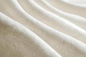 Soft, beige woven fabric with a subtle grid texture, draped in gentle waves, showcasing its intricate weave pattern photo