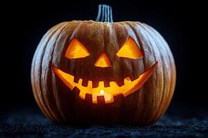A glowing jack-o-lantern with a sinister grin, illuminated from within against a dark background photo