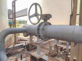 A pipe with a valve and a pipe in front of it photo
