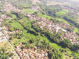 Beautiful 4K drone photography of a dense village in a valley. Housing Industry. Panoramic Landscape. Graphic Resources. Social Issues. Aerial Landscape Photography Concept photo