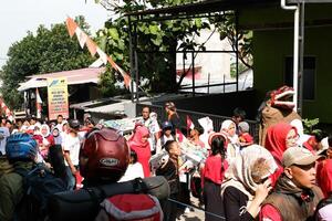 Cibiru, West Java, Indonesia - August 17, 2024. A group of people are attending a carnival in various costumes to Celebrate the 79th Anniversary of the Independence Day of the Republic of Indonesia. photo