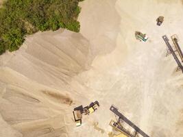 Landscape of truck and conveyor belt in the middle of sand pit. Mining Industry. Panoramic Landscape. Mining material transportation. Sand and stone mining. Drone Photography. Aerial Photography photo