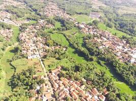 Beautiful 4K drone photography of a dense village in a valley. Housing Industry. Panoramic Landscape. Graphic Resources. Social Issues. Aerial Landscape Photography Concept photo