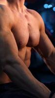 Rest in sports center. Shirtless man having break during workout. Athletic man sitting on a simulator with a flask of water. Close-up. Vertical video
