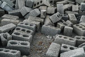 a pile of cinder blocks made of gray concrete, a material for building a house photo