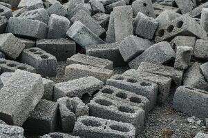 a pile of cinder blocks made of gray concrete, a material for building a house photo