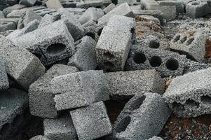 a pile of cinder blocks made of gray concrete, a material for building a house photo