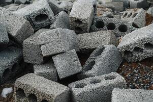 a pile of cinder blocks made of gray concrete, a material for building a house photo