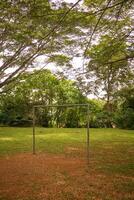 A goal post on a makeshift soccer field in a neighborhood park turns empty spaces into lively game time for local children in Melaka, Malaysia. photo