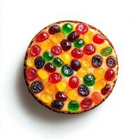 Christmas fruitcake with colorful candied fruits, isolated on white background, top view photo