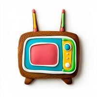 Unusual gingerbread cookie shaped like a retro TV set with antennas, decorated with colorful icing, isolated on white, top view photo