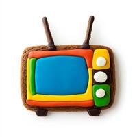 Unusual gingerbread cookie shaped like a retro TV set with antennas, decorated with colorful icing, isolated on white, top view photo