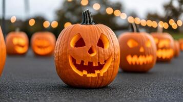 A lineup of intricately carved pumpkins on display each with unique designs from spooky faces to elaborate patterns with a festive autumn backdrop and string lights photo