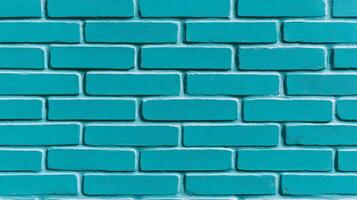 Closeup of a textured painted brick wall in vibrant turquoise showing rough brush strokes and slightly uneven coverage perfect for a bold and modern design aesthetic photo