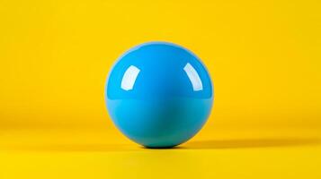 Isolated shot of a single bubble gum ball in bright blue centered on a vibrant yellow background with plenty of empty space photo