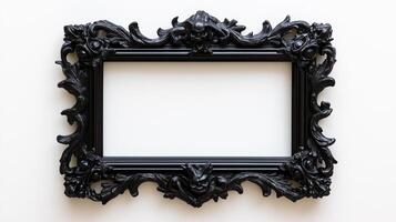 Overhead shot of a gothic picture frame with creepy designs like gargoyles and twisted branches finished in a matte black isolated on a white background photo
