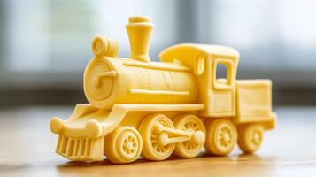 Close up of a whimsical butter sculpture of a vintage train engine complete with wheels and a smokestack placed on a wooden table rich yellow tone textured details photo