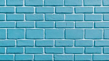 Diagonal shot of a painted brick wall in sky blue with a distressed and textured surface weathered look ideal for a vintage or coastal theme photo