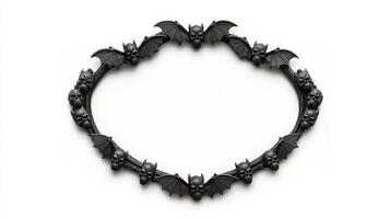 Top view of a circular Halloween frame with gothic inspired bat wings and skulls around the edges finished in dark distressed metal isolated on a white background photo