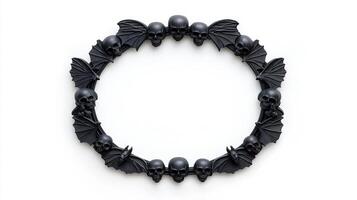 Top view of a circular Halloween frame with gothic inspired bat wings and skulls around the edges finished in dark distressed metal isolated on a white background photo
