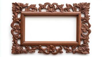 Wide angle shot of a vintage wooden picture frame with elaborate carvings and a deep mahogany finish isolated on a white background showcasing its rich texture and detail photo