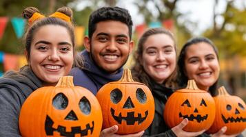A group photo of contestants holding their uniquely decorated pumpkins smiling proudly with a backdrop of autumn trees and colorful banners