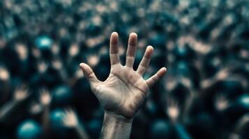 Closeup of a persons hand reaching out desperately through a thick crowd the crowd blurred to highlight the sense of urgency photo