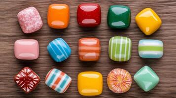 Flat lay of a variety of bubble gum wrappers in retro designs arranged in a circular pattern on a wooden surface photo