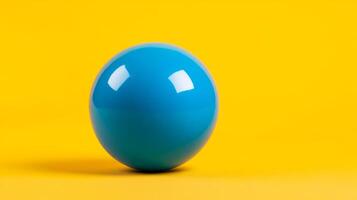 Isolated shot of a single bubble gum ball in bright blue centered on a vibrant yellow background with plenty of empty space photo