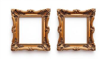 Wide angle shot of a pair of matching ornate picture frames with baroque style gold detailing isolated on a white background positioned side by side photo