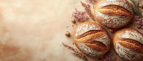 Freshly Baked Artisan Bread Loaves with Rustic Decorations on a Warm Background photo