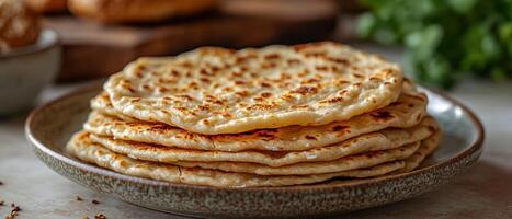Freshly Cooked Homemade Flatbreads on a Rustic Plate in a Cozy Kitchen Setting photo