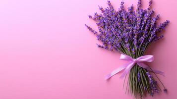 Beautiful Bouquet of Lavender Flowers Tied with a Purple Ribbon on a Pink Background photo
