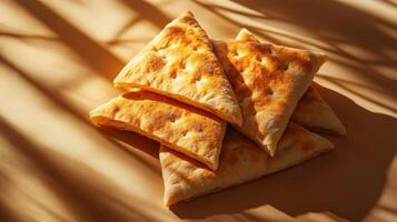 Freshly Baked Flatbread Triangles on a Warm Sunlit Surface with Shadows photo