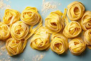 Fresh Homemade Tagliatelle Pasta Nests on a Light Blue Background with Flour Dusting photo