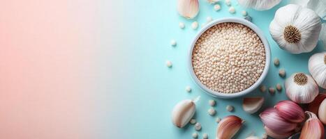 Fresh Garlic Bulbs and Pearl Couscous on Light Blue Background - Culinary Ingredients for Healthy Cooking photo