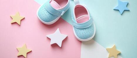 Adorable Baby Shoes on Colorful Pastel Background with Decorative Stars photo