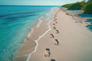 Serene Tropical Beach with Footprints in the Sand and Clear Blue Ocean Waves photo