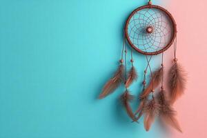 Dreamcatcher with Feathers Hanging Against a Split Blue and Pink Background photo