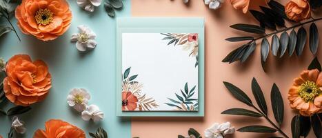 Flat Lay of Floral Stationery with Orange and White Flowers on Pastel Background photo