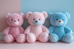 Three Adorable Plush Teddy Bears in Pink and Blue Sitting Against a Pastel Background photo