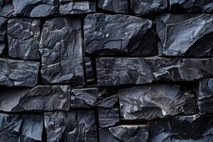 Dark grey stone wall texture background showing rough surface of natural material forming pattern photo