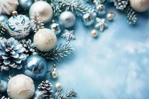 Christmas composition with blue and silver baubles and fir tree branches on a blue background photo